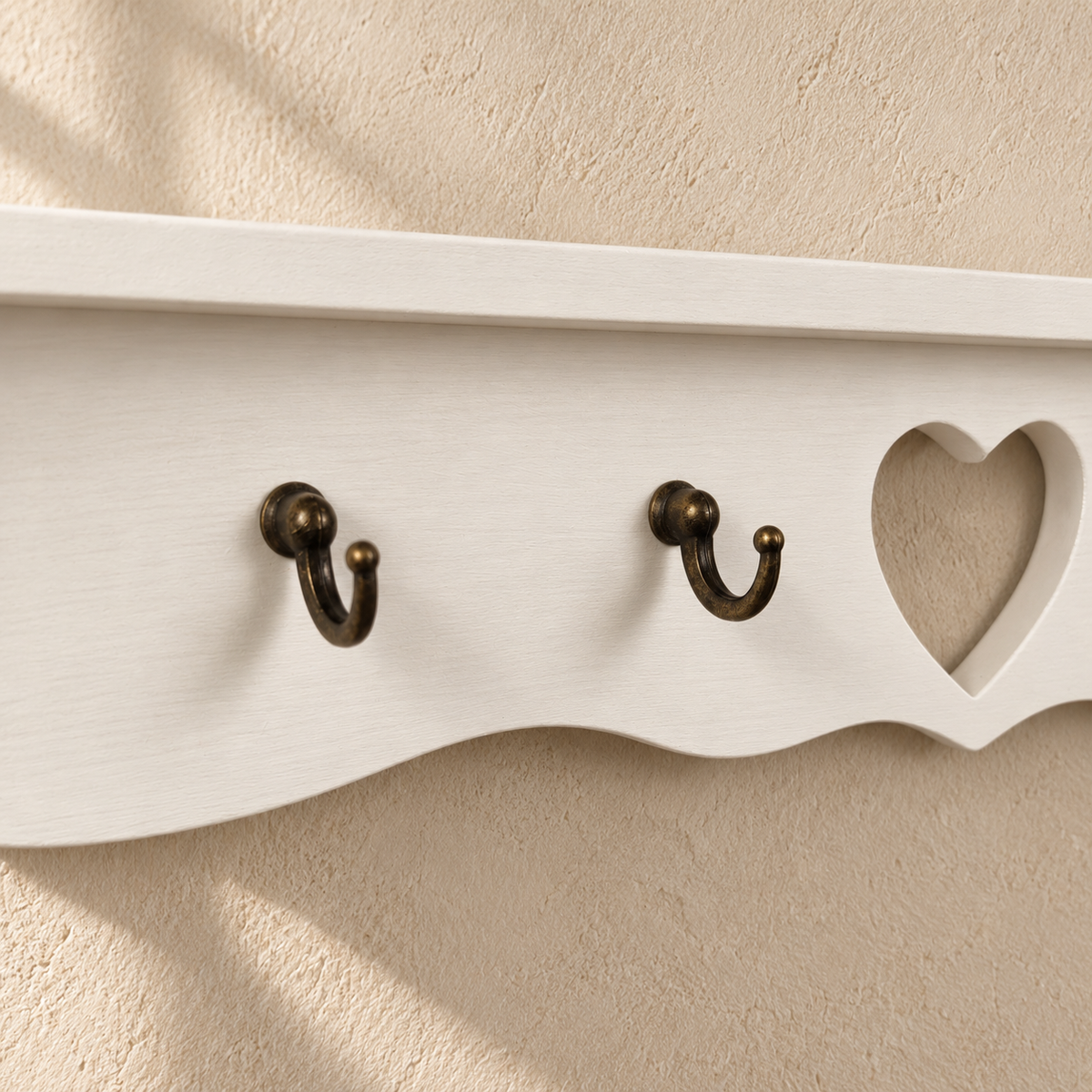 Dettaglio dei ganci metallici bronzati, del cuore traforato e della finitura Bianco della mensola porta tazze Domea.